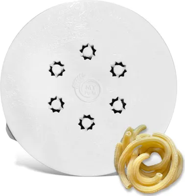 A white pasta maker die with star-shaped openings and a pile of freshly made pasta.