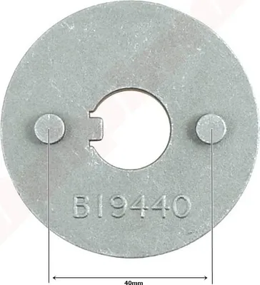 A close-up, top-down view of a metal disc with a central opening and two small protrusions. Text and measurement lines are visible.