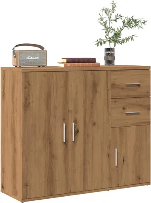 A wooden sideboard with drawers and doors, decorated with a radio and books.