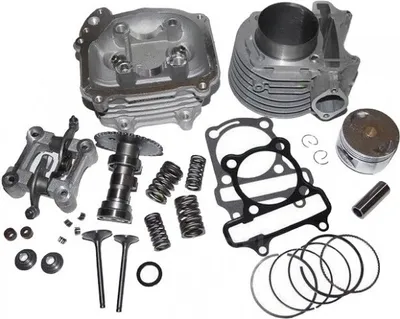 A collection of motorcycle engine parts laid out on a white background.