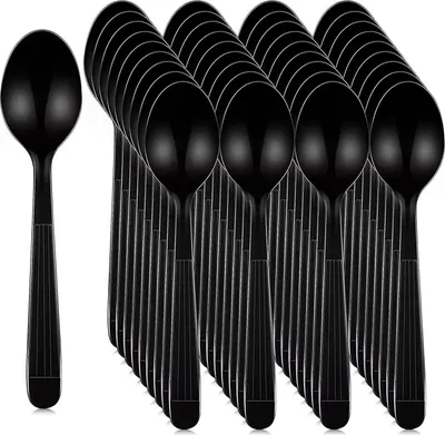 A group of black plastic spoons arranged in rows.