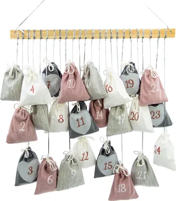 A hanging advent calendar with 24 small fabric bags, each numbered.