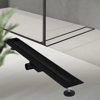 A black linear shower drain is shown on a tiled floor.