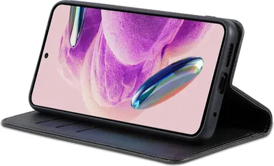 A black flip case for a smartphone is shown in a studio setting, with the phone screen displaying a colorful abstract wallpaper.