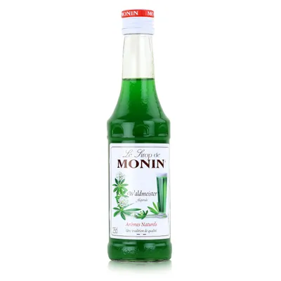 A bottle of Monin Waldmeister syrup against a white background.