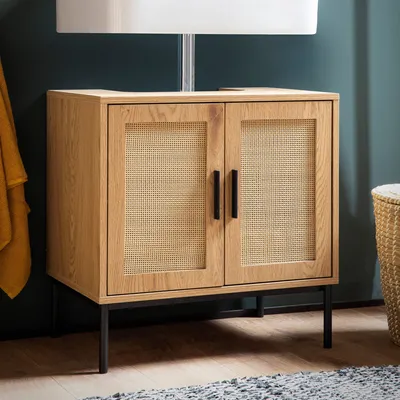 A wooden cabinet with cane doors is shown in a room.