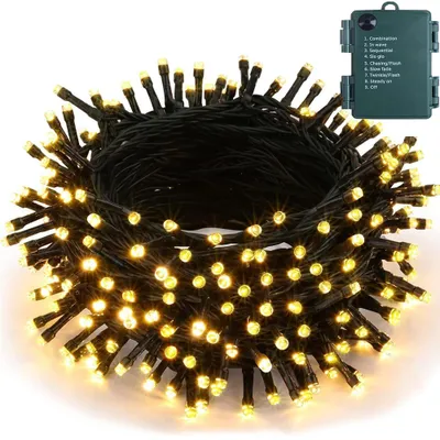 A coiled string of warm white LED lights with a green battery pack.