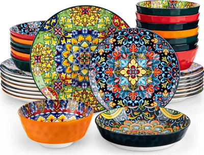A collection of colorful, patterned ceramic plates and bowls arranged on a white background.
