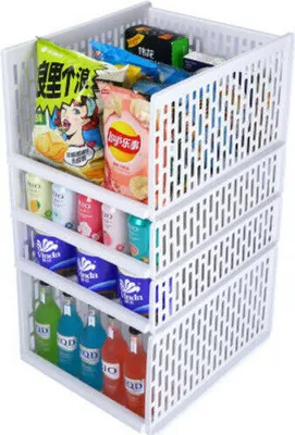 A white stacking storage organizer filled with various snacks and drinks.