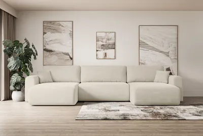 A sectional sofa in a living room setting with artwork on the wall.