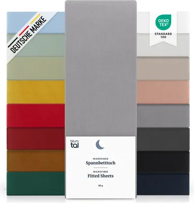 A display of multiple fitted sheets in various colors, with a central focus on a gray sheet and packaging.