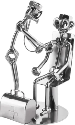A metal sculpture of a doctor examining a patient, with a medical bag nearby.