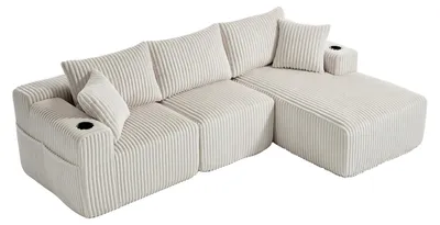 Imagen del producto de Sofá de esquina de tres plazas, tapizado en terciopelo canalé color beige, con 5 cojines y bolsillos laterales