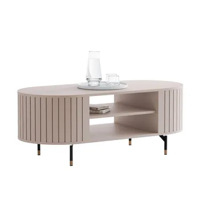 A modern, oval-shaped coffee table with fluted sides and a shelf underneath, displayed on a white background. Two glasses and a carafe of water are placed on top.
