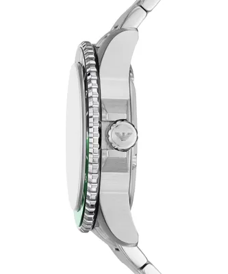 Side view of a silver watch with a green accent.