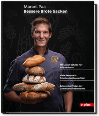 A man holding a stack of bread loaves.