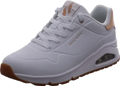 A white Skechers Uno sneaker with rose gold accents and a brown sole is shown against a white background.