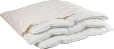 A white pillow is folded and stacked on a white background.