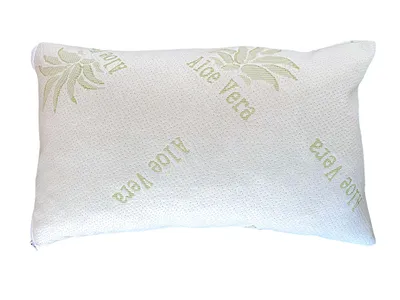 A white pillow with green aloe vera patterns and text.