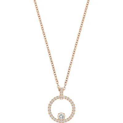 A rose gold necklace with a circular pendant encrusted with small clear stones and a larger clear stone in the center.