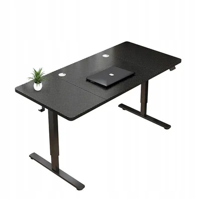 A black adjustable standing desk with a laptop and a small potted plant on it, shown against a white background.