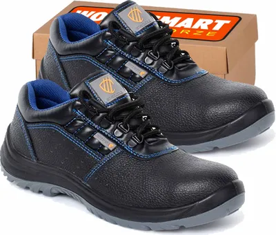 A pair of black work boots with blue accents and a cardboard box in the background.