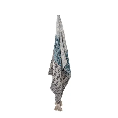 A blanket is hanging from a hook against a white background.