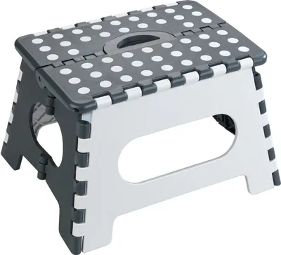 A foldable step stool with a polka dot pattern on the top surface.