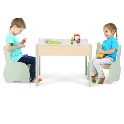 Two children sitting at a wooden table with chairs, playing with toys.