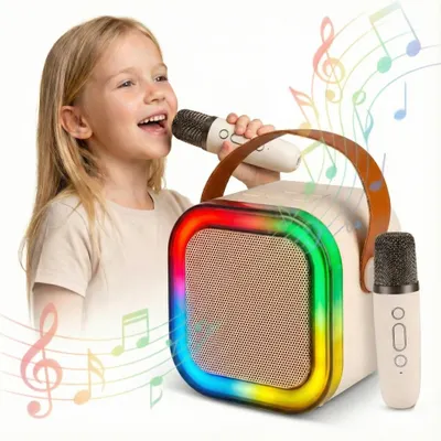 A young girl is happily singing into a microphone connected to a portable karaoke speaker with colorful RGB lights.