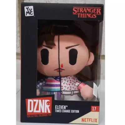 A plush toy of the character Eleven from Stranger Things, shown in its retail packaging.