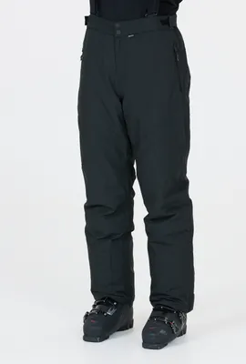 A person wearing black ski pants and ski boots against a white background.