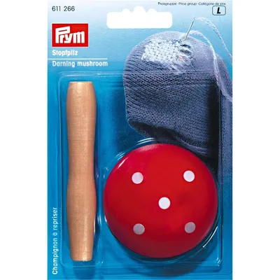 A darning mushroom kit in its original packaging, showing the mushroom-shaped darning tool and a sock with a hole being darned.
