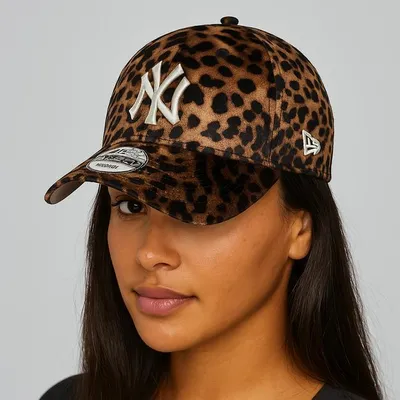 A woman wearing a leopard-print New Era NY Yankees baseball cap.