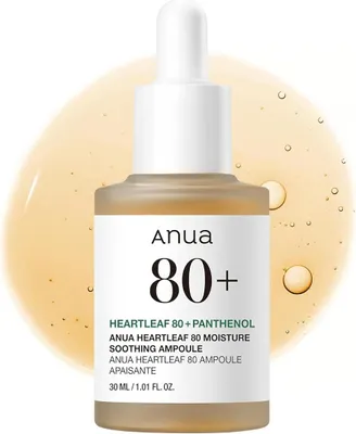 A bottle of Anua Heartleaf 80+ Moisture Soothing Ampoule with a dropper, set against a blurred yellow background with bubbles.