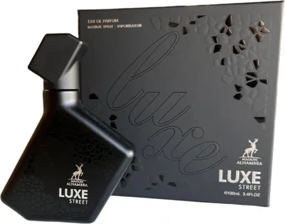 A black perfume bottle and its packaging are displayed against a white background.