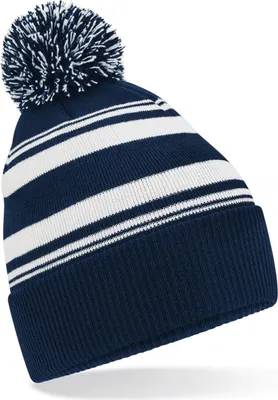 A close-up studio shot of a striped beanie with a pom-pom.