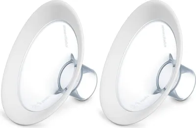 Two white breast pump flanges are shown against a white background.