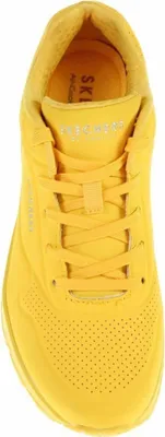 A top-down view of a yellow sneaker.