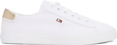 A single white sneaker with a gold heel accent.