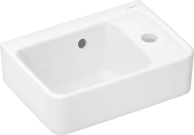 A white ceramic sink with two holes on its surface, set against a white background.