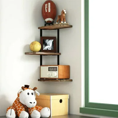 A corner shelf unit with various decorative items and a stuffed animal in front of it.