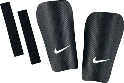 A pair of black Nike shin guards with two black straps, shown against a white background.