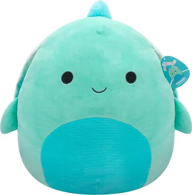 A teal-colored plush toy turtle with a light blue belly and a small light blue fin on its head. It has black eyes and a smiling mouth. A tag is attached to its right side.