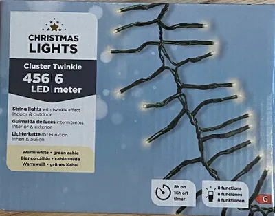 The image shows the packaging of Christmas lights, with a portion of the lights themselves visible.