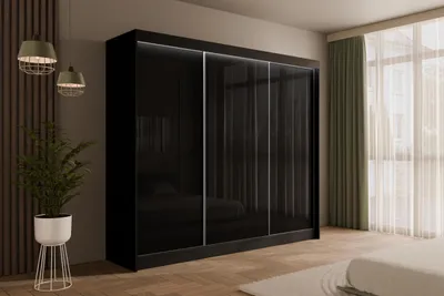 A modern bedroom with a large black sliding door wardrobe, a plant, and pendant lights.