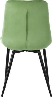 The back view of a single green velvet chair with black metal legs, isolated on a white background.