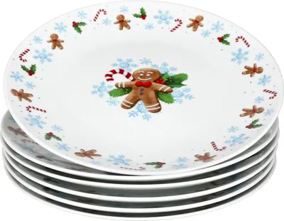 A stack of Christmas-themed plates with gingerbread man designs.
