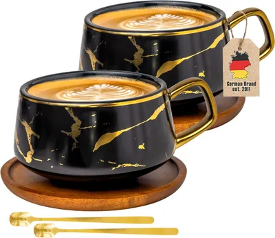 Produktbild von Intirilife 2x Tasse aus Keramik im Marmor Design in Schwarz - ca. 200 ml - Kaffeetasse, Teetasse mit Holz Untersetzer Becher, Trinkbecher für Kaffee, Tee, Milch, Kakao und vielem mehr