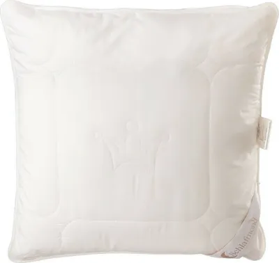 A white pillow with a crown embossed on it, placed on a white background.